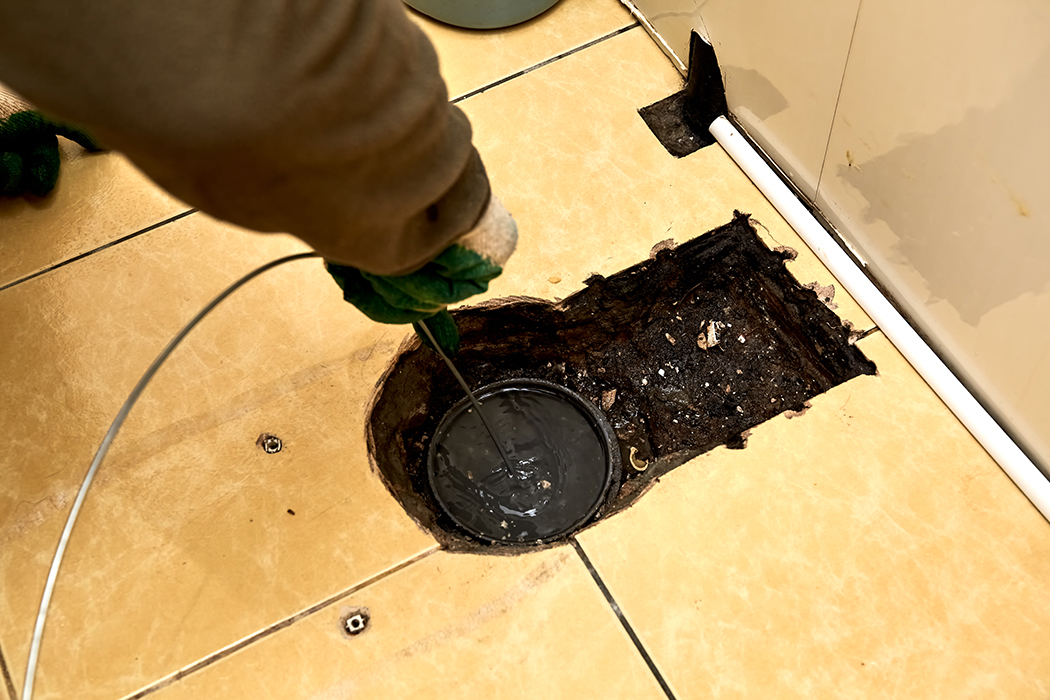 Technician draining and cleaning a sewer